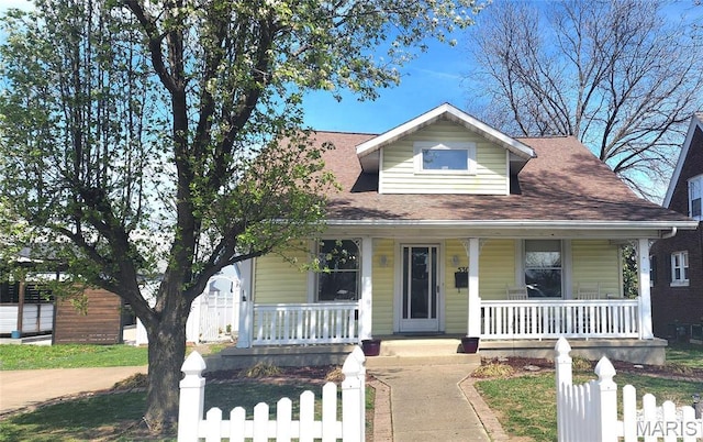 530 W Holmes, Chester, IL 62233 - bungalow featuring covered porch, a fenced front yard, and a shingled roof