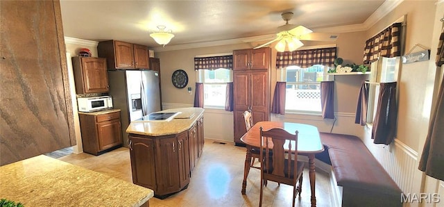 530 W Holmes, Chester, IL 62233 - kitchen featuring white microwave, ornamental molding, a kitchen island, ceiling fan, and light countertops