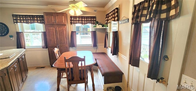 530 W Holmes, Chester, IL 62233 - dining room with crown molding, healthy amount of natural light, ceiling fan, and a wainscoted wall