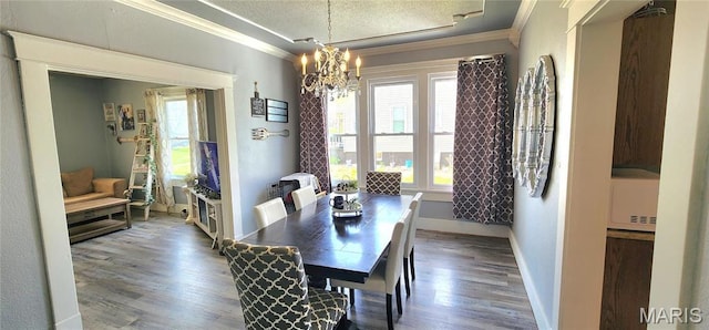 530 W Holmes, Chester, IL 62233 - dining space with crown molding, a chandelier, wood finished floors, and baseboards