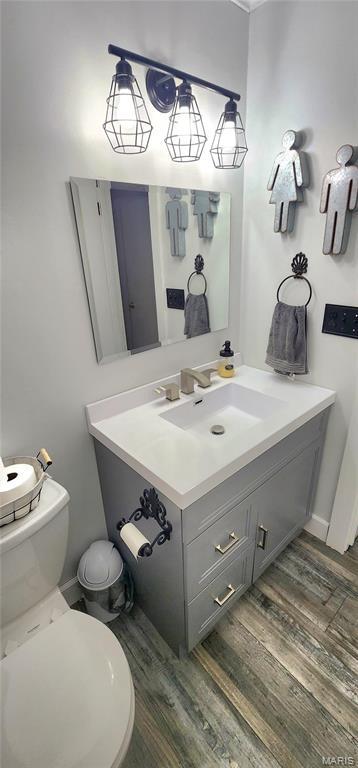 530 W Holmes, Chester, IL 62233 - half bath with vanity, wood finished floors, and toilet