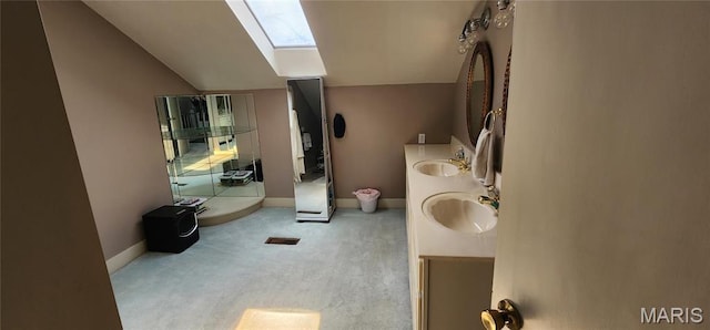 530 W Holmes, Chester, IL 62233 - full bathroom with vaulted ceiling, a skylight, double vanity, and baseboards