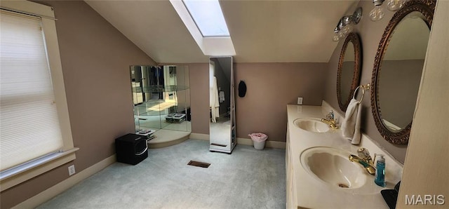530 W Holmes, Chester, IL 62233 - full bath featuring lofted ceiling, a skylight, double vanity, and baseboards