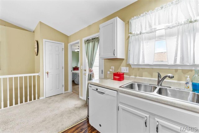 114 Fort Dodge Dr, Wright City, MO 63390 - kitchen featuring white dishwasher, a sink, vaulted ceiling, healthy amount of natural light, and white cabinets