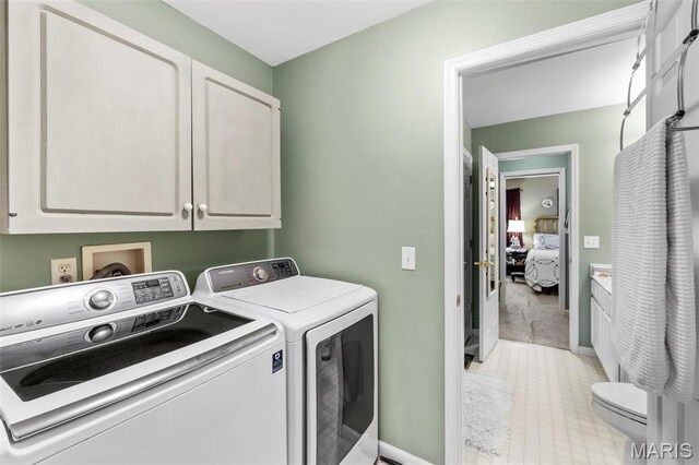 114 Fort Dodge Dr, Wright City, MO 63390 - laundry area featuring separate washer and dryer, cabinet space, and baseboards