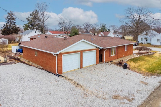 132 S Duncan St, Marine, IL 62061 - view of side of property featuring a garage, driveway, brick siding, a residential view, and a shingled roof