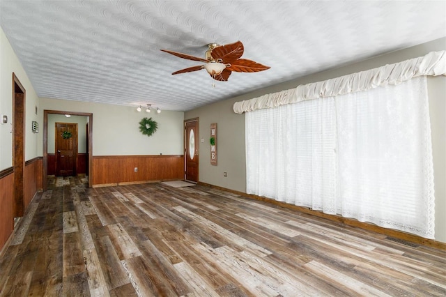 132 S Duncan St, Marine, IL 62061 - empty room featuring wainscoting, wood finished floors, a ceiling fan, and wooden walls