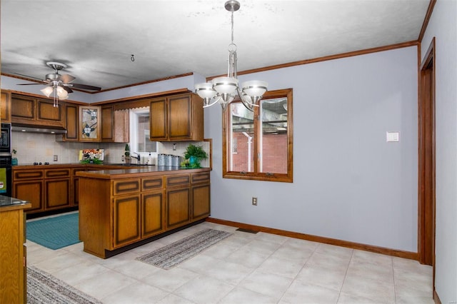 132 S Duncan St, Marine, IL 62061 - kitchen featuring brown cabinetry, dark countertops, tasteful backsplash, ornamental molding, and a chandelier