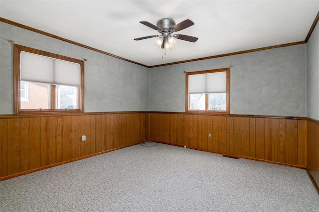 132 S Duncan St, Marine, IL 62061 - spare room with a wainscoted wall, wood walls, a ceiling fan, and carpet flooring