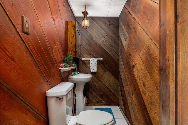 132 S Duncan St, Marine, IL 62061 - bathroom with wood walls, toilet, and tile patterned floors