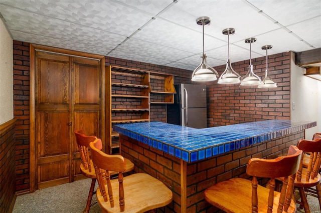 132 S Duncan St, Marine, IL 62061 - indoor dry bar with freestanding refrigerator, brick wall, decorative light fixtures, carpet, and wood walls