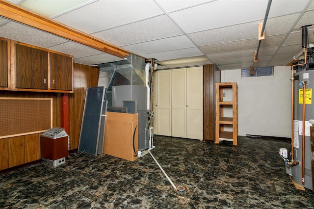 132 S Duncan St, Marine, IL 62061 - finished below grade area featuring water heater, a paneled ceiling, wood walls, and heating unit