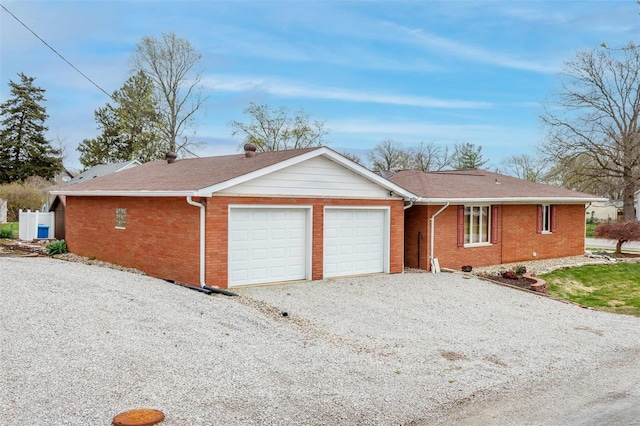 132 S Duncan St, Marine, IL 62061 - ranch-style house featuring an attached garage, brick siding, gravel driveway, and a shingled roof