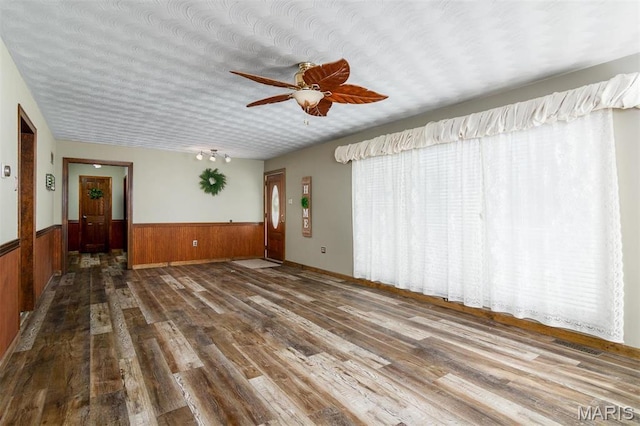 132 S Duncan St, Marine, IL 62061 - empty room featuring a wainscoted wall, wood finished floors, ceiling fan, and wood walls
