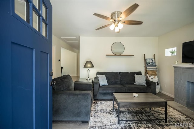 409 Jett Ave, Saint Louis, MO 63125 - living room featuring ceiling fan, a brick fireplace, and baseboards