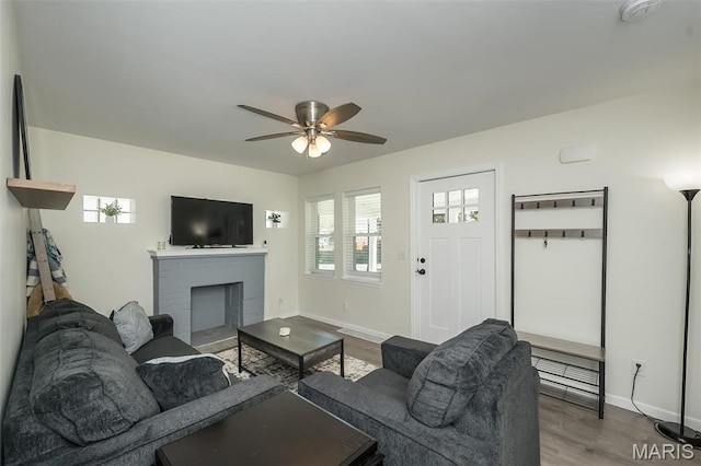 409 Jett Ave, Saint Louis, MO 63125 - living room featuring a ceiling fan, baseboards, a brick fireplace, and wood finished floors