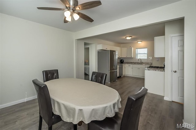 409 Jett Ave, Saint Louis, MO 63125 - dining room featuring dark wood-style flooring, a ceiling fan, and baseboards