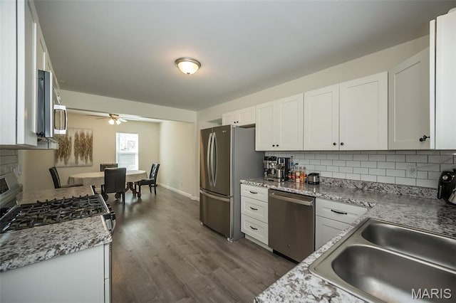 409 Jett Ave, Saint Louis, MO 63125 - kitchen with appliances with stainless steel finishes, backsplash, white cabinetry, and ceiling fan