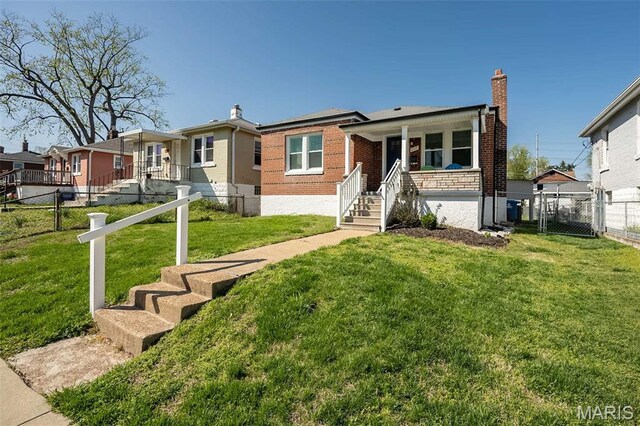 409 Jett Ave, Saint Louis, MO 63125 - view of front of house featuring a porch, brick siding, a gate, and a chimney