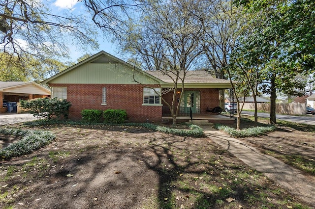 605 W Washington St, Kennett, MO 63857 - view of front of house featuring brick siding, covered porch, and fence