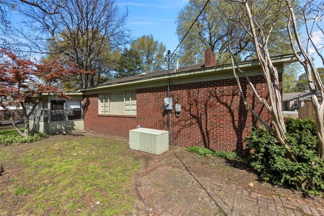 605 W Washington St, Kennett, MO 63857 - view of side of home featuring brick siding, fence, and a chimney