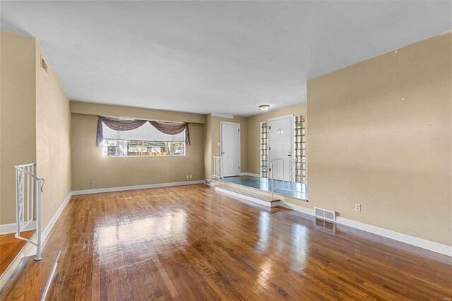 605 W Washington St, Kennett, MO 63857 - unfurnished living room with wood finished floors and baseboards
