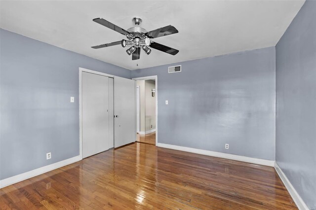 605 W Washington St, Kennett, MO 63857 - unfurnished bedroom with baseboards, wood finished floors, a closet, and a ceiling fan