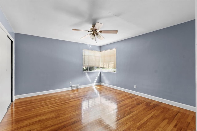 605 W Washington St, Kennett, MO 63857 - empty room with ceiling fan, wood finished floors, and baseboards
