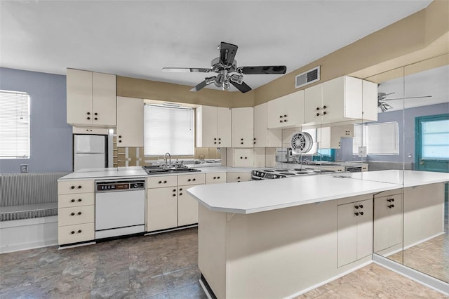 605 W Washington St, Kennett, MO 63857 - kitchen with white appliances, ceiling fan, a sink, light countertops, and white cabinetry