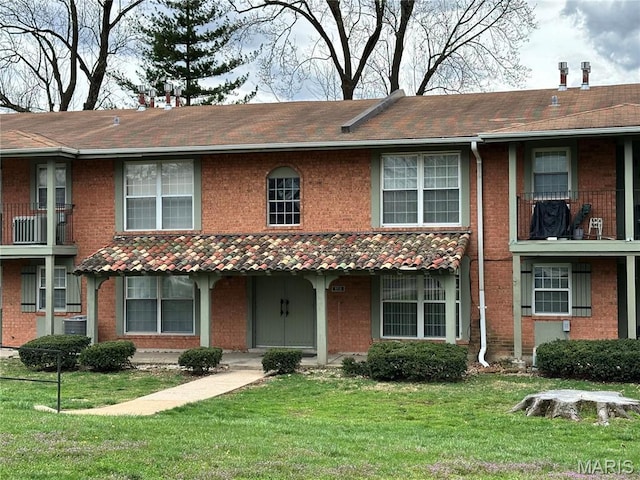 8736 Santa Bella Dr Unit G, Hazelwood, MO 63042 - view of property with brick siding, a front yard, roof with shingles, and a chimney
