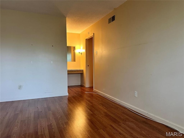 8736 Santa Bella Dr Unit G, Hazelwood, MO 63042 - spare room featuring wood finished floors, baseboards, and a textured ceiling