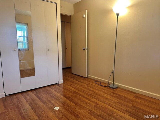 8736 Santa Bella Dr Unit G, Hazelwood, MO 63042 - unfurnished bedroom featuring wood finished floors and baseboards