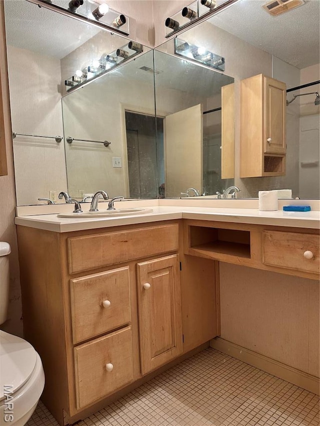 8736 Santa Bella Dr Unit G, Hazelwood, MO 63042 - bathroom featuring toilet, vanity, and a textured ceiling