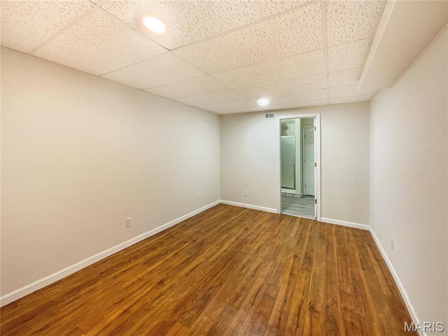 1 Pine Forest Ct, Dardenne Prairie, MO 63368 - empty room featuring wood finished floors, baseboards, and a drop ceiling