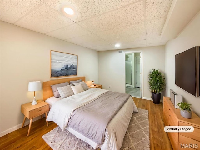 1 Pine Forest Ct, Dardenne Prairie, MO 63368 - bedroom with wood finished floors, a drop ceiling, baseboards, and ensuite bath