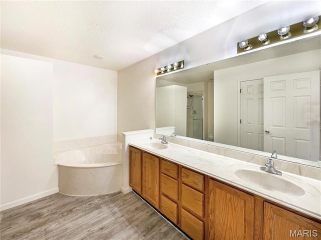 1 Pine Forest Ct, Dardenne Prairie, MO 63368 - full bathroom featuring a textured ceiling, double vanity, wood finished floors, a bath, and a stall shower