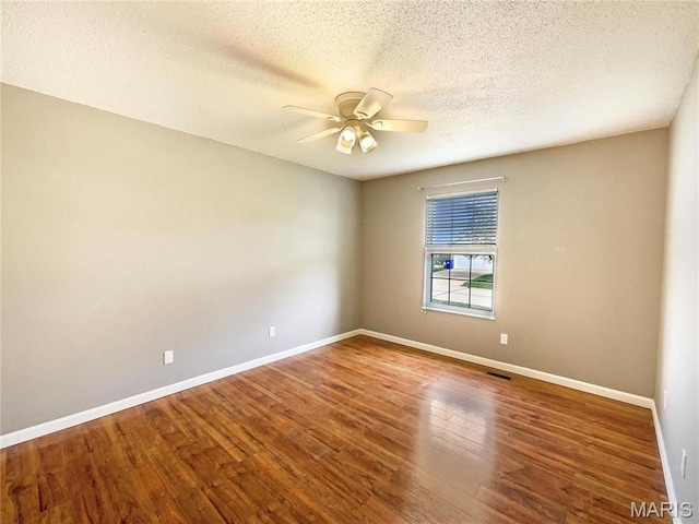 1 Pine Forest Ct, Dardenne Prairie, MO 63368 - empty room featuring ceiling fan, baseboards, wood finished floors, and a textured ceiling