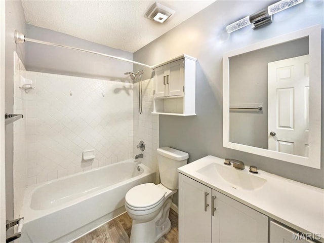 1 Pine Forest Ct, Dardenne Prairie, MO 63368 - full bath featuring wood finished floors, toilet, washtub / shower combination, a textured ceiling, and vanity