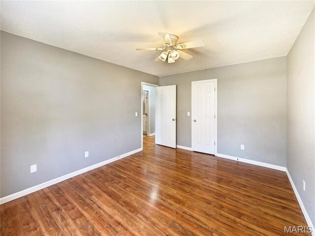 1 Pine Forest Ct, Dardenne Prairie, MO 63368 - unfurnished bedroom featuring baseboards, wood finished floors, a ceiling fan, and a textured ceiling