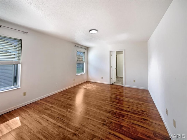 1 Pine Forest Ct, Dardenne Prairie, MO 63368 - spare room featuring wood finished floors, a textured ceiling, and baseboards