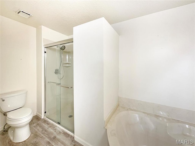 1 Pine Forest Ct, Dardenne Prairie, MO 63368 - full bathroom with toilet, wood finished floors, a stall shower, a bath, and a textured ceiling