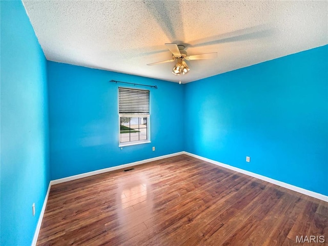 1 Pine Forest Ct, Dardenne Prairie, MO 63368 - empty room featuring a ceiling fan, a textured ceiling, wood finished floors, and baseboards