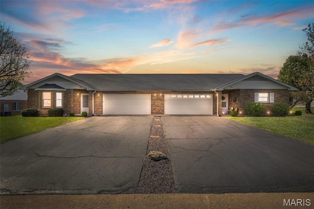 302 Bayberry Ln, Farmington, MO 63640 - single story home with brick siding, driveway, a lawn, and an attached garage
