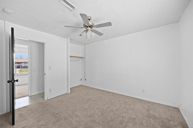47 E Adams Dr E, St Louis, IL 62206 - unfurnished bedroom featuring carpet floors, a closet, a ceiling fan, baseboards, and a textured ceiling