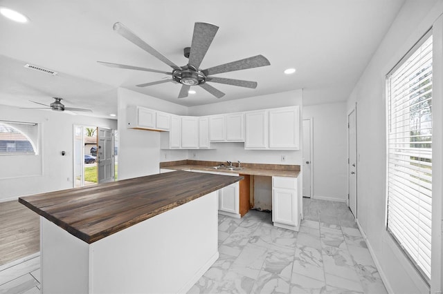 47 E Adams Dr E, St Louis, IL 62206 - kitchen featuring butcher block countertops, recessed lighting, a sink, white cabinets, and ceiling fan