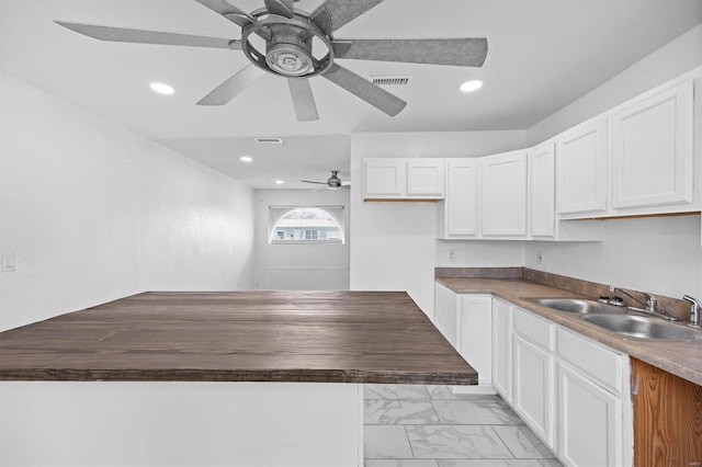 47 E Adams Dr E, St Louis, IL 62206 - kitchen with a sink, ceiling fan, light marble finish flooring, white cabinetry, and butcher block countertops
