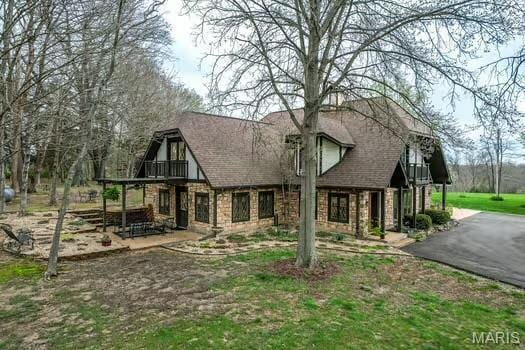 762 Crider Ln, Union, MO 63084 - view of front of property with stone siding, a balcony, and a patio area