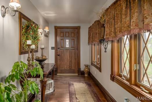 762 Crider Ln, Union, MO 63084 - doorway featuring a chandelier, dark wood-type flooring, and baseboards