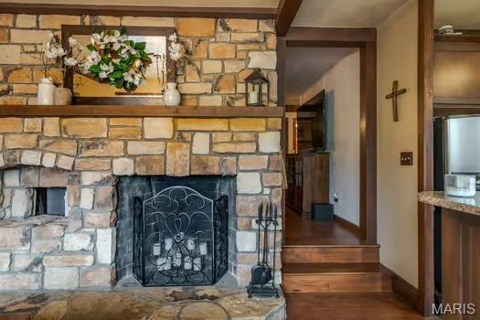 762 Crider Ln, Union, MO 63084 - detailed view of a stone fireplace, baseboards, and stainless steel fridge