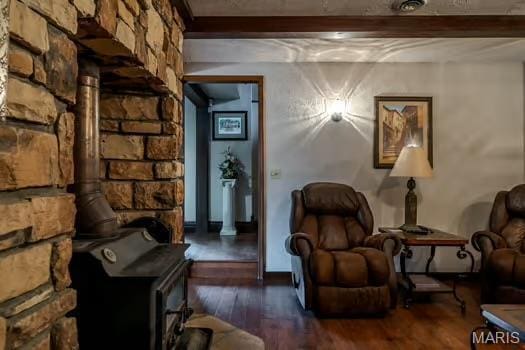 762 Crider Ln, Union, MO 63084 - sitting room with a wood stove, wood finished floors, beamed ceiling, and ornate columns